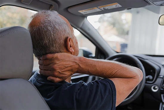 man holding neck after car accident