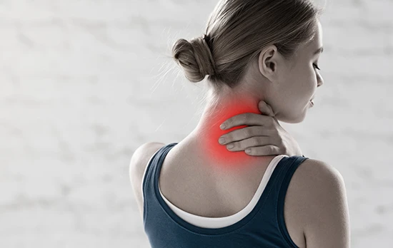 woman holding neck in pain